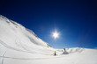 Alpine scenic of two snowboarders shaping a jump