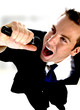 young man singing into microphone on an abstract background young man singing into microphone on an abstract background