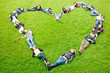 happy group of friends making a heart shape - smiling