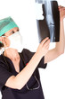 Attractive female doctor looking at a x-ray of a knee