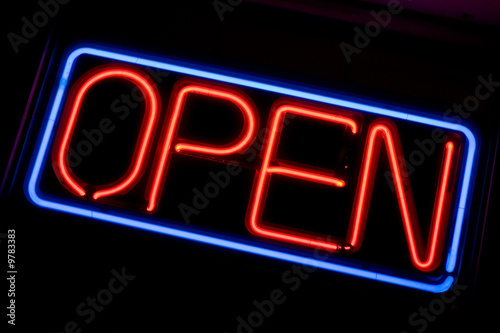 Photo: A neon OPEN sign glowing red in the window of a restaurant A neon OPEN sign glowing red in the window of a restaurant