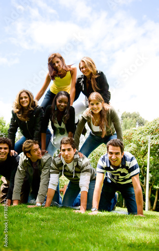 Photo: happy group of friends smiling outdoors in a park happy group of friends smiling outdoors in a park