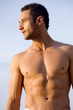 fashion muscular man portrait at the beach