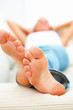 Woman lying on sofa with macro of feet