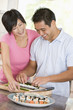 Photo: Couple Preparing Sushi Together Couple Preparing Sushi Together