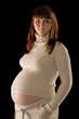 happy pregnant woman portrait isolated on black background
