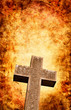 An old stone cross with a dramatic textured background/