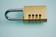 Open metal padlock with a number combination