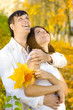 young couple looking up in autumn park