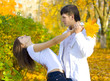 young couple dancing in autumn park young couple dancing in autumn park