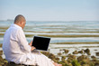 man using laptop while having his holiday