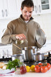 young man preparing lunch in the kitchen