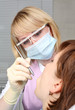 Photo: Female dentist examining a patient Female dentist examining a patient