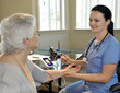 young nurse measuring the patient's blood pressure young nurse measuring the patient's blood pressure