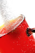 freshly brewed cup of tea with falling sugar granules