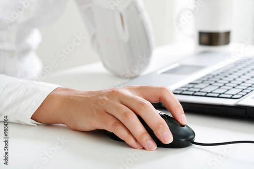 Photo: Image of female hand touching computer mouse Image of female hand touching computer mouse