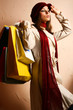 Portrait of young beautiful women with her shopping bags