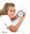 Closeup portrait of young woman lying on bed with alarm clock Closeup portrait of young woman lying on bed with alarm clock