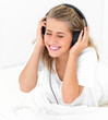 Closeup portrait of a woman lying and listening to music Closeup portrait of a woman lying and listening to music