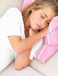 Closeup portrait of a young woman sleeping on a sofa Closeup portrait of a young woman sleeping on a sofa