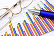 Colorful business chart, blue pen and eyeglasses