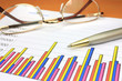 Colorful business chart, eyeglasses and pen
