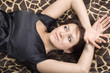 young beauty woman in black dress lies on a bed young beauty woman in black dress lies on a bed