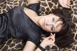 young beautiful woman in black dress lies on a bed young beautiful woman in black dress lies on a bed
