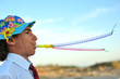 Foto: Young boy in shirt and tie blowing in blowers Young boy in shirt and tie blowing in blowers