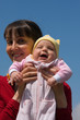 Baby with mom on blue sky background Baby with mom on blue sky background