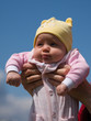 Little baby on mother's hands on blue sky background Little baby on mother's hands on blue sky background