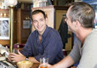 Foto: Two friends drinking beer in a bar Two friends drinking beer in a bar