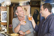 Foto: Two friends drinking beer in a bar Two friends drinking beer in a bar
