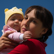 Baby with mom on blue sky background Baby with mom on blue sky background