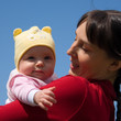 Baby with mom on blue sky background Baby with mom on blue sky background