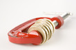 Stack of pound coins in red clamp on white background
