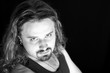 Portrait of the good looking guy on the black background