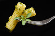 Italian pasta with pesto on fork isolated on black Italian pasta with pesto on fork isolated on black