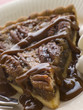 Slice Of Pecan Pie With Caramel Sauce And A Fork