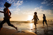 Photo: Three girls at the beach running by the ocean at sunset Three girls at the beach running by the ocean at sunset