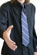 Man offering handshake Black shirt tie holding out right hand