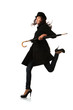 Fashion model in black with umbrella running over white