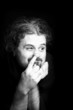 Black and white portrait of the young man picking his nose