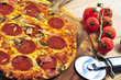 Freshly baked pepperoni pizza on wooden board
