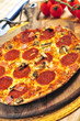 Freshly baked pepperoni pizza on wooden board
