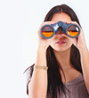 Woman looking through binoculars isolated on white Woman looking through binoculars isolated on white