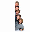 Happy young friends behind a billboard