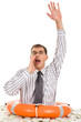 Portrait of man inside lifebuoy with raised arm