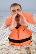 Image of troubled man wearing life vest crying for help