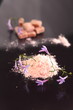Brown sugar cubes and flour on black surface